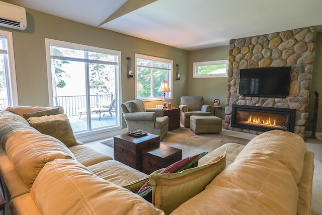 living room featuring a wall mounted AC, light carpet, and a fireplace