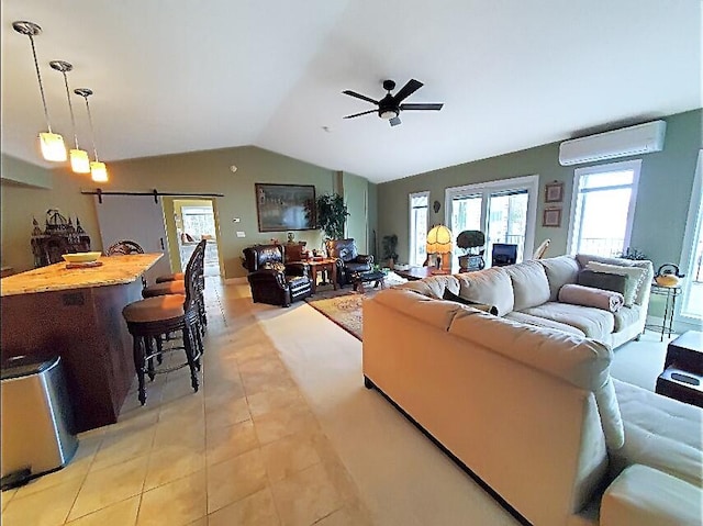 living room with a wall mounted AC, light tile patterned floors, ceiling fan, and vaulted ceiling