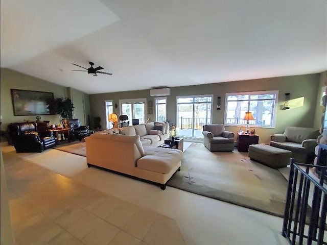 living room with vaulted ceiling, ceiling fan, a wall unit AC, and plenty of natural light