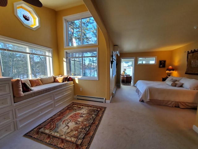 bedroom with a baseboard heating unit and light colored carpet