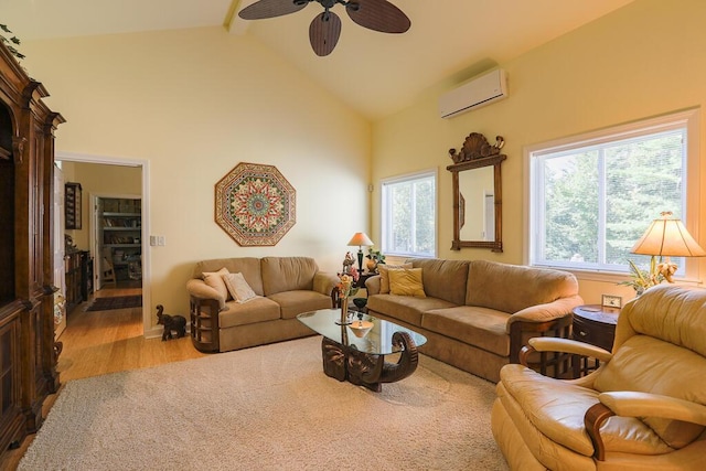 124 Collette Rd, Holden, ME 04429 - living area with a wall mounted AC, a ceiling fan, wood finished floors, high vaulted ceiling, and beam ceiling