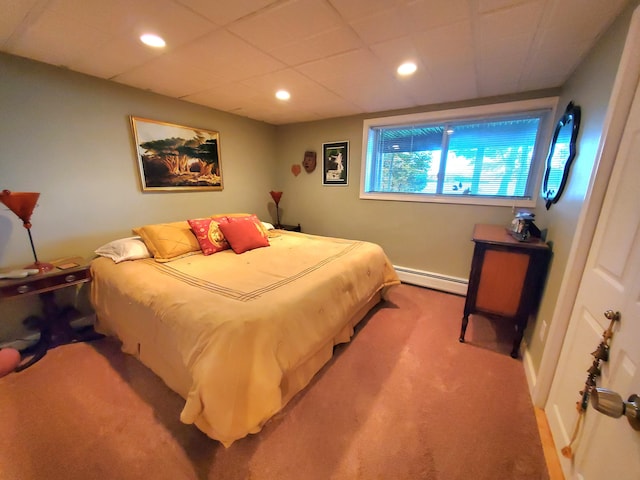 bedroom featuring a baseboard heating unit and light colored carpet