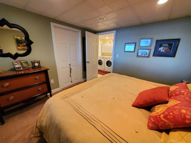 carpeted bedroom featuring washer and clothes dryer