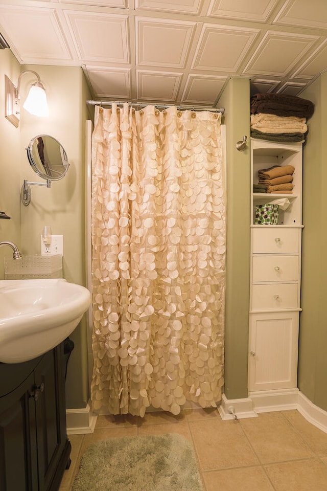 bathroom with walk in shower, vanity, and tile patterned floors