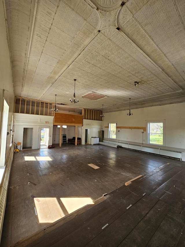 interior space featuring wood-type flooring and baseboard heating