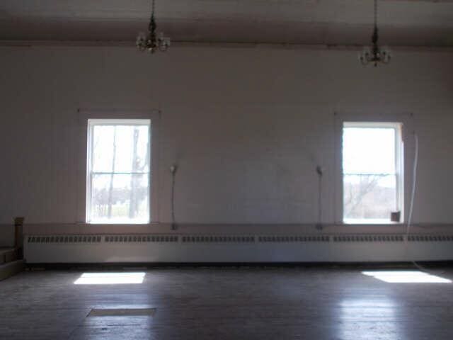 562 Ledge Hill Rd, Corinth, ME 04427 - unfurnished room with wood finished floors, a chandelier, and plenty of natural light