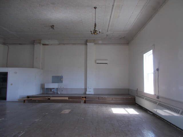562 Ledge Hill Rd, Corinth, ME 04427 - unfurnished room with an inviting chandelier and a baseboard radiator