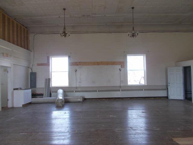 562 Ledge Hill Rd, Corinth, ME 04427 - interior space featuring electric panel, wood-type flooring, and a baseboard radiator