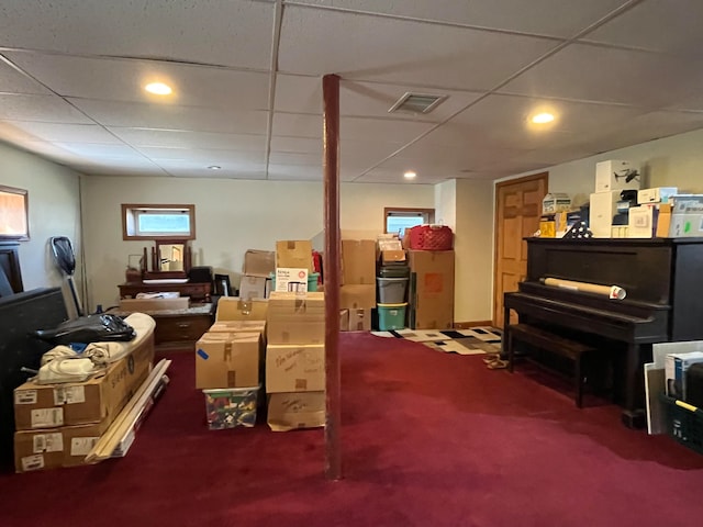 basement with carpet flooring and a paneled ceiling