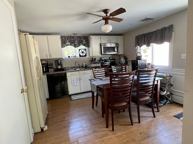 kitchen featuring ceiling fan, light wood-type flooring, a healthy amount of sunlight, and black appliances