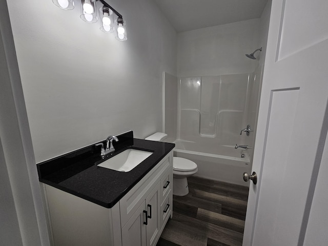full bathroom featuring wood finished floors, toilet, vanity, and bathtub / shower combination