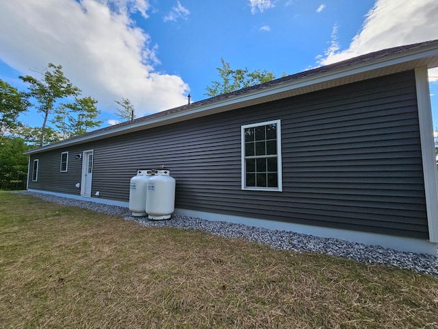 view of property exterior featuring a lawn