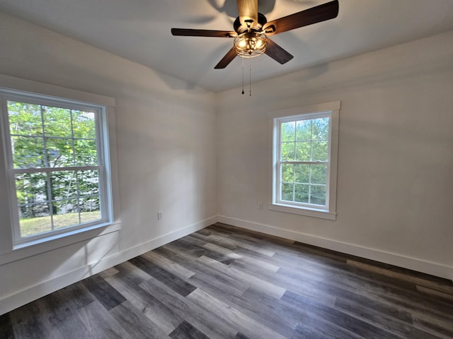 unfurnished room with dark wood finished floors, baseboards, and ceiling fan