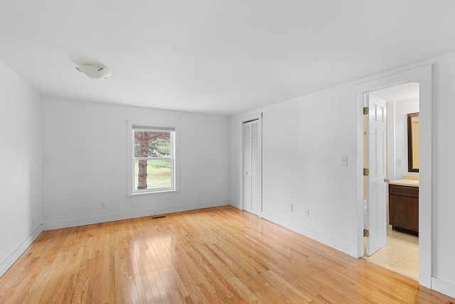 empty room with light hardwood / wood-style flooring