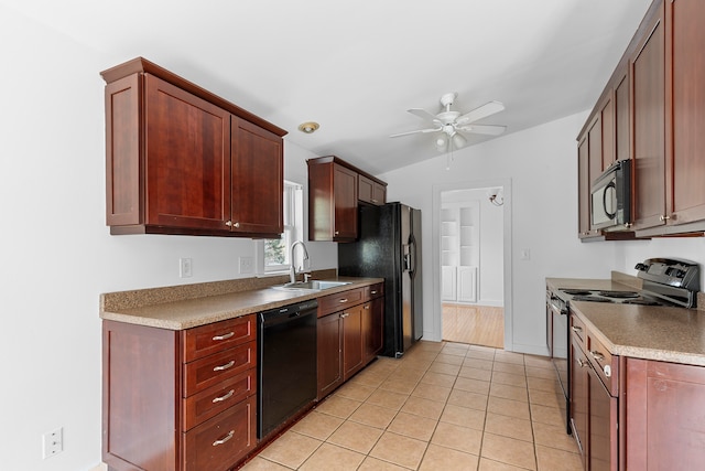 kitchen with vaulted ceiling, black appliances, sink, light tile patterned floors, and ceiling fan