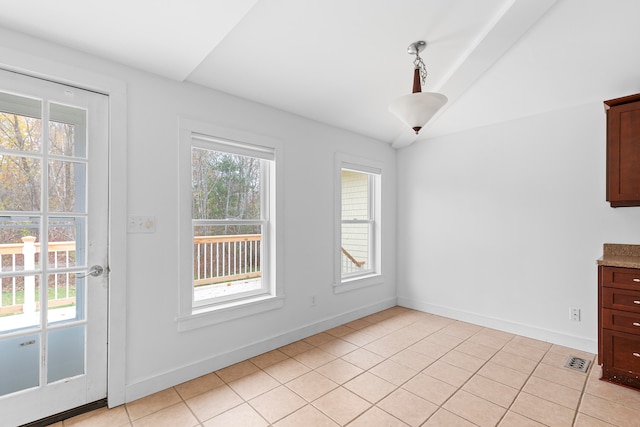 unfurnished dining area featuring light tile patterned floors