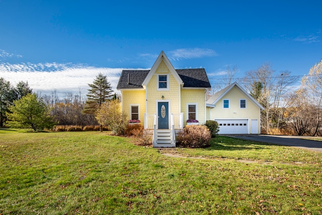 view of front of property featuring a garage and a front lawn