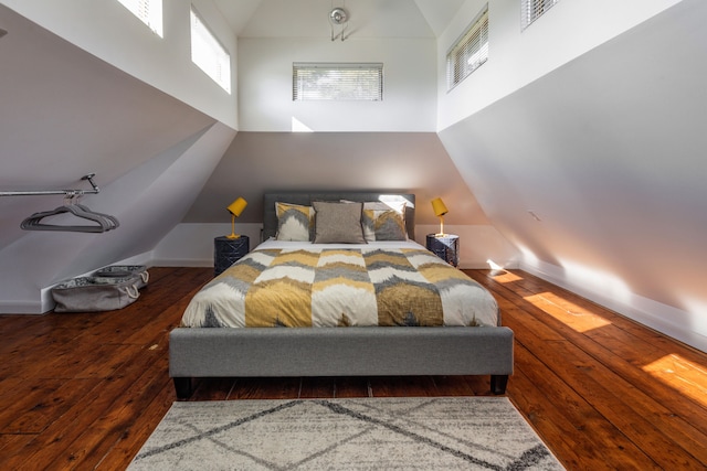 bedroom featuring lofted ceiling and dark wood-type flooring