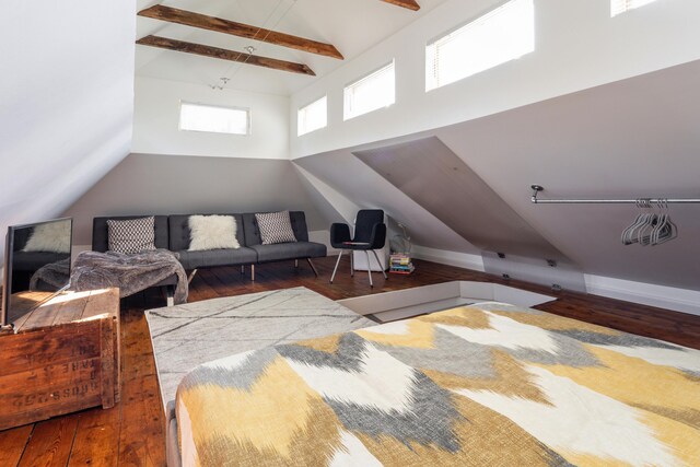 interior space with wood-type flooring and lofted ceiling with beams