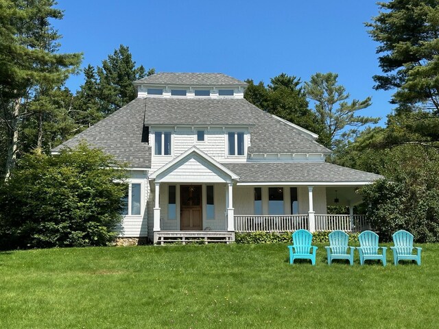 view of front facade with a front lawn and covered porch