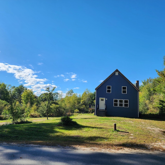 view of side of home with a lawn