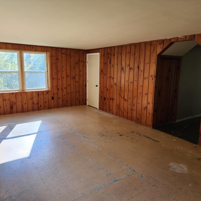 spare room with wood walls