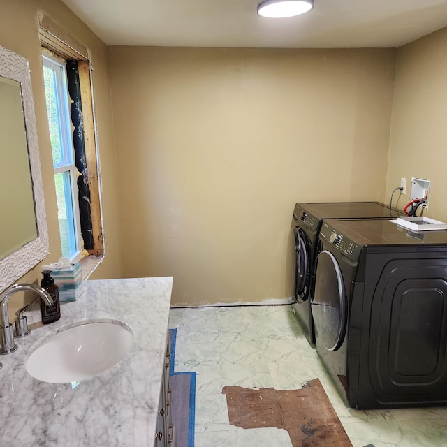 laundry room with washing machine and dryer and sink