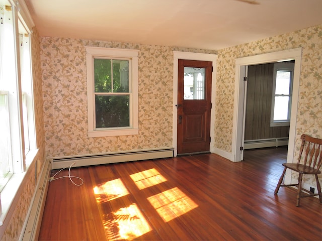 foyer with a baseboard radiator, dark hardwood / wood-style flooring, and a healthy amount of sunlight