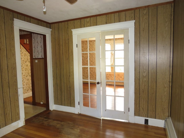 doorway to outside featuring ceiling fan, baseboard heating, plenty of natural light, and dark hardwood / wood-style flooring