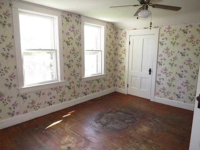 empty room featuring ceiling fan and dark hardwood / wood-style flooring