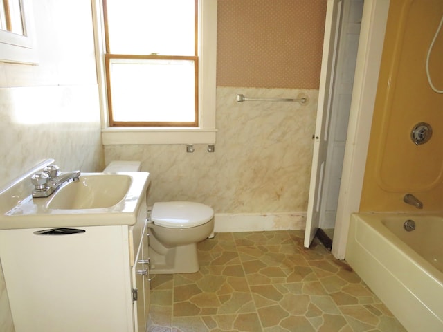 full bathroom featuring  shower combination, vanity, and toilet