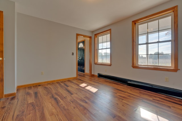 20 Kristas Way, Gorham, ME 04038 - empty room featuring wood finished floors and a baseboard radiator
