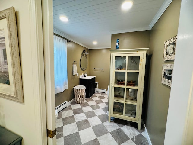 bathroom with tile patterned floors, ornamental molding, baseboards, and a baseboard radiator