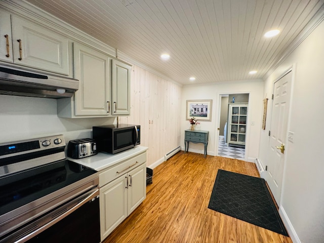 kitchen featuring a baseboard radiator, stainless steel appliances, extractor fan, light countertops, and light wood-type flooring