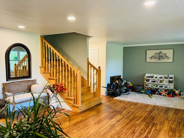 interior space featuring recessed lighting, wood finished floors, and crown molding