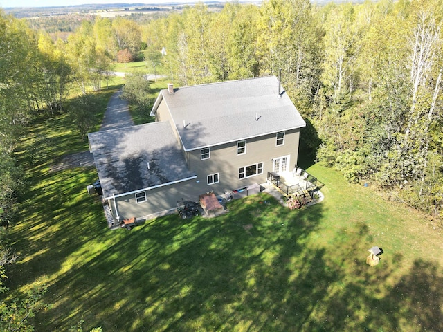 birds eye view of property with a wooded view