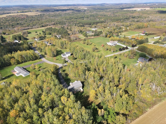 birds eye view of property featuring a wooded view