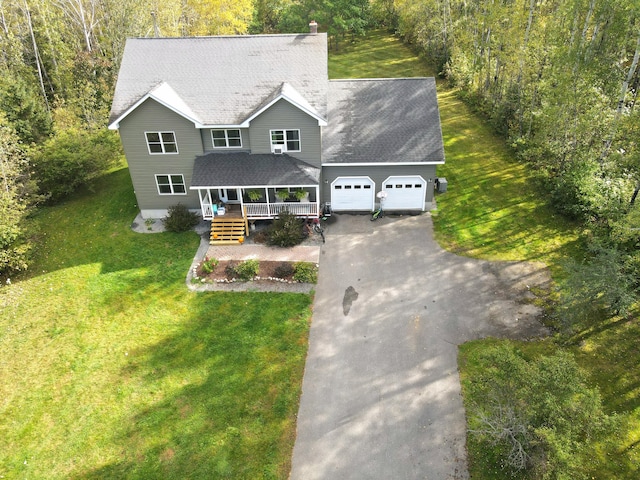 view of front of house with a front yard, roof with shingles, a porch, a garage, and aphalt driveway