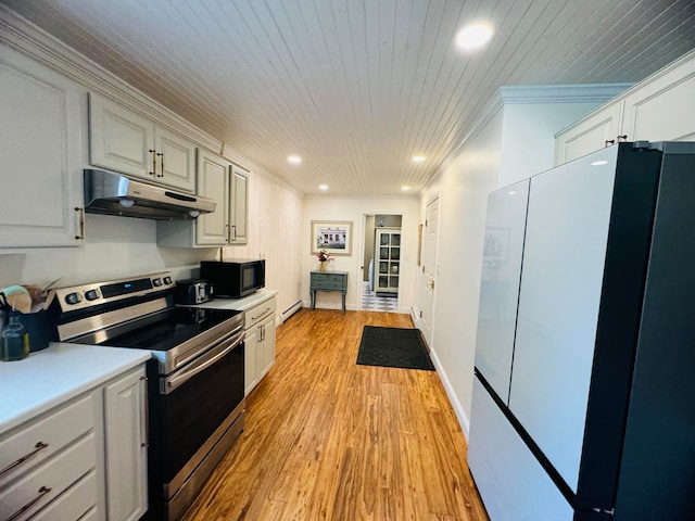 kitchen with recessed lighting, freestanding refrigerator, stainless steel range with electric cooktop, black microwave, and under cabinet range hood