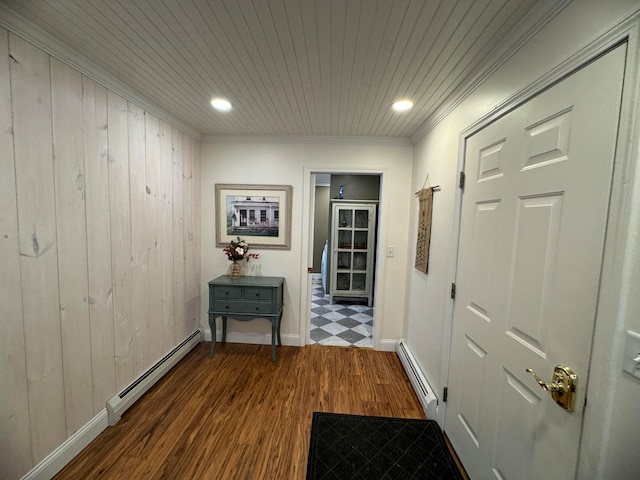 hallway featuring dark wood finished floors, wooden ceiling, a baseboard heating unit, and ornamental molding