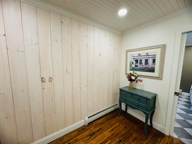 hall featuring a baseboard radiator, baseboards, dark wood-style flooring, and crown molding