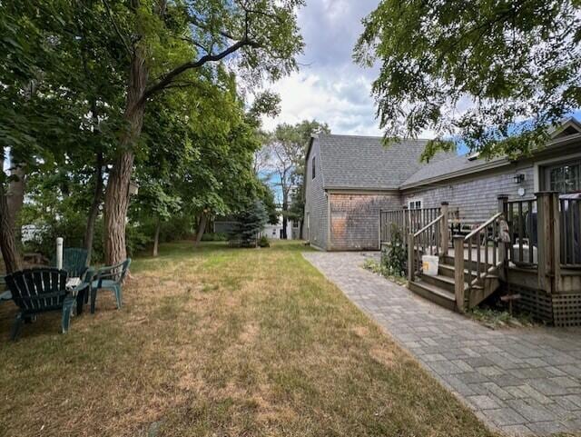 view of yard featuring a wooden deck