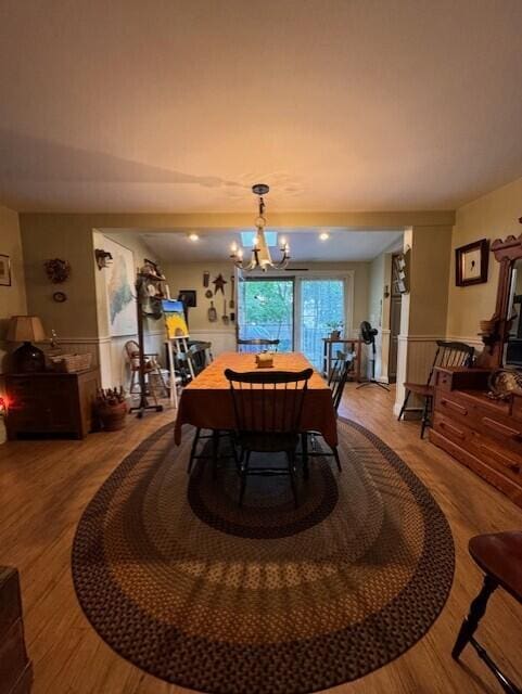 dining space with an inviting chandelier and wood finished floors