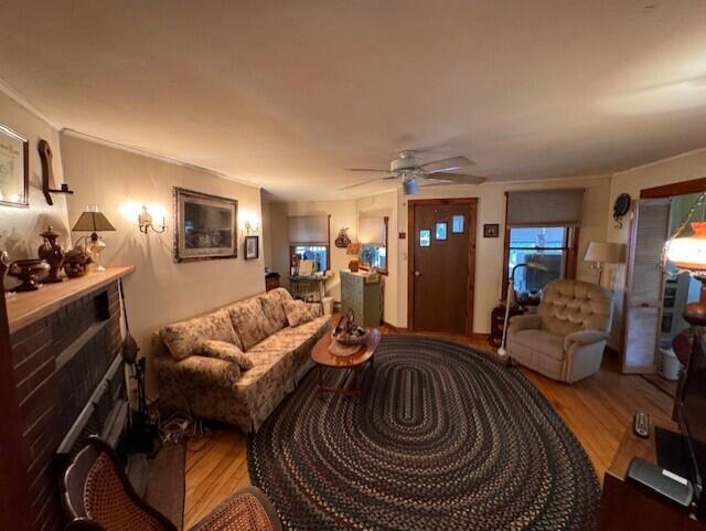 living room with ceiling fan and wood finished floors