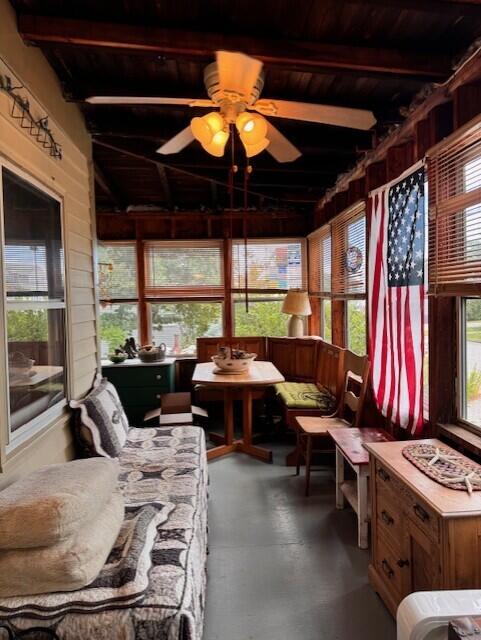 sunroom with outdoor lounge area, beamed ceiling, and ceiling fan