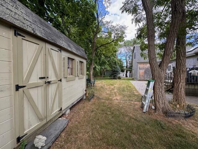 view of yard with a storage shed and an outdoor structure