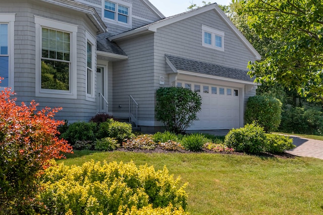 view of home's exterior featuring a garage and a lawn