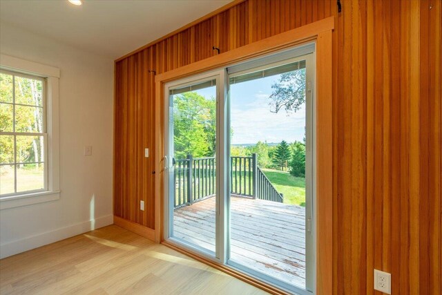 entryway featuring wood walls and light hardwood / wood-style flooring