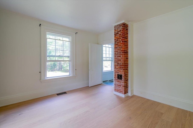 unfurnished living room featuring crown molding and light hardwood / wood-style floors