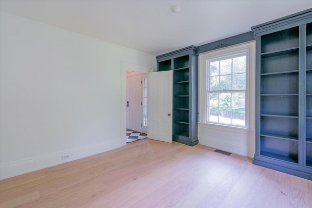 empty room with light hardwood / wood-style flooring